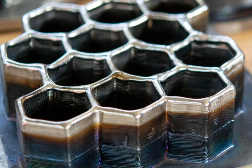 Metal honeycomb structure built up from stacked deposited metal layers, representing automotive applications for laser cladding solutions