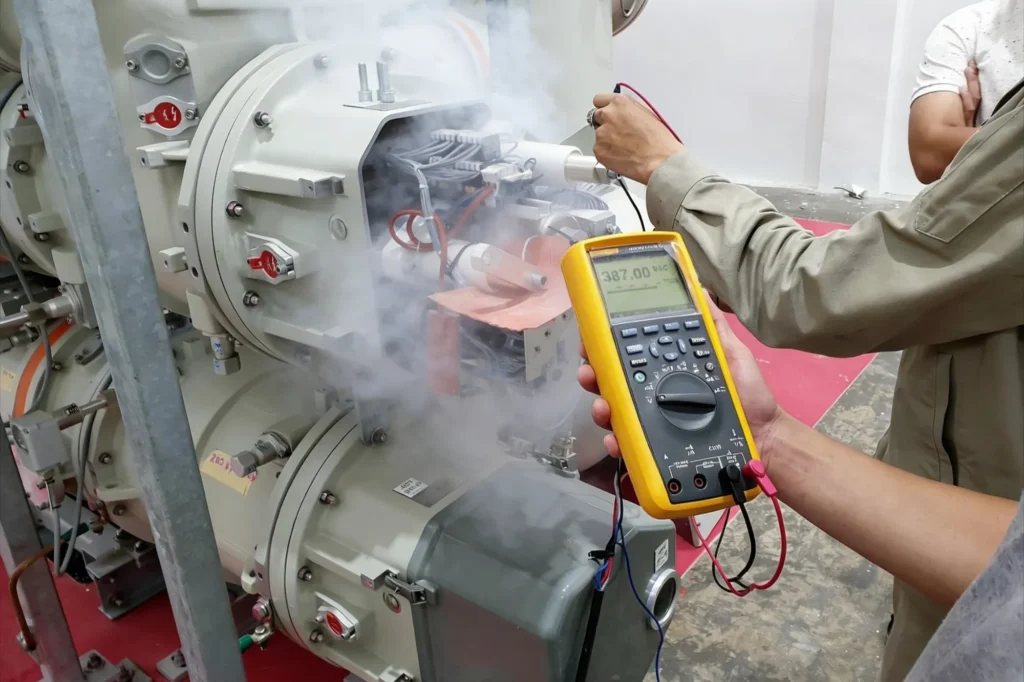 A technician holding a digital multimeter probes the wiring of grey electrical equipment as white smoke rises from it, representing automotive electronics applications for electronic fume extraction
